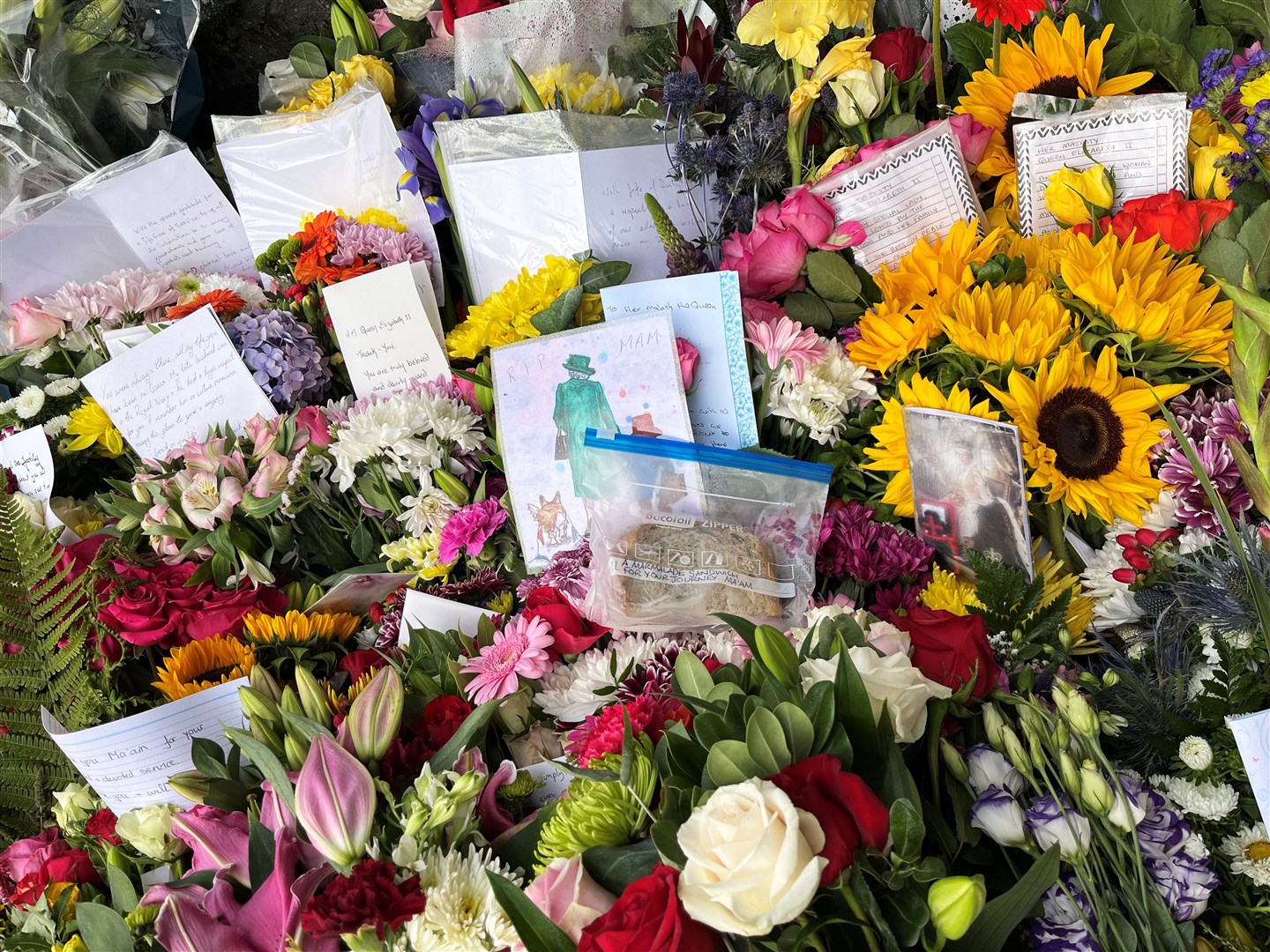 A marmalade sandwich among the flowers laid by members of the public (Aine Fox/PA)