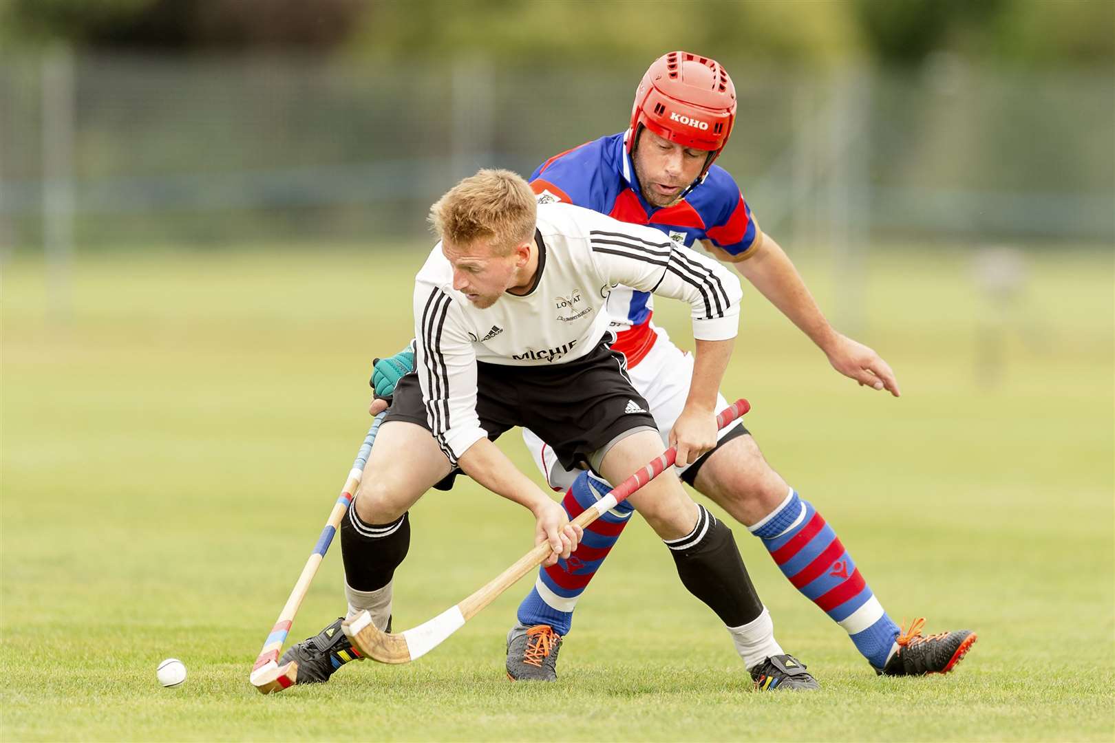 James Hutchison puts a tackle in on Lorne Mackay (Lovat) in a Tulloch Homes Camanachd Cup semi final played at The Bught, Inverness.