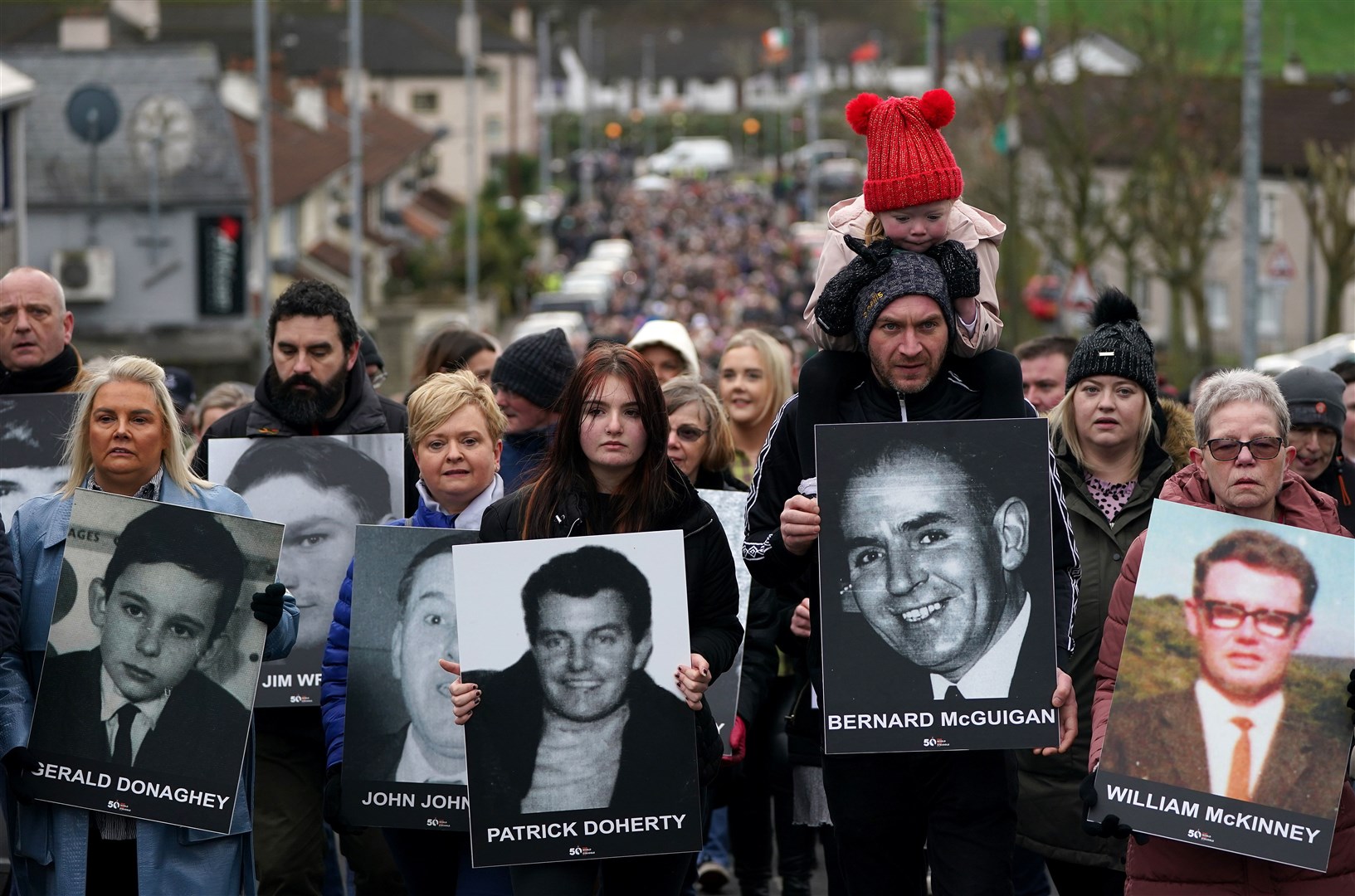 Maisie McLaughlin, great grand-daughter of Bloody Sunday victim Bernard McGuigan, sits on shoulders during the remembrance walk (Brian Lawless/PA)