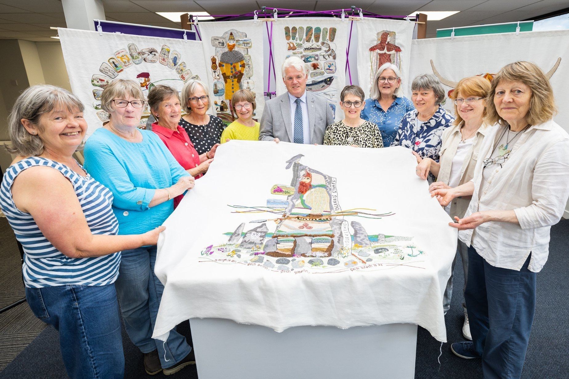 The stitchers show off the Calanais Stones tapestry panel. Picture: Paul Campbell.
