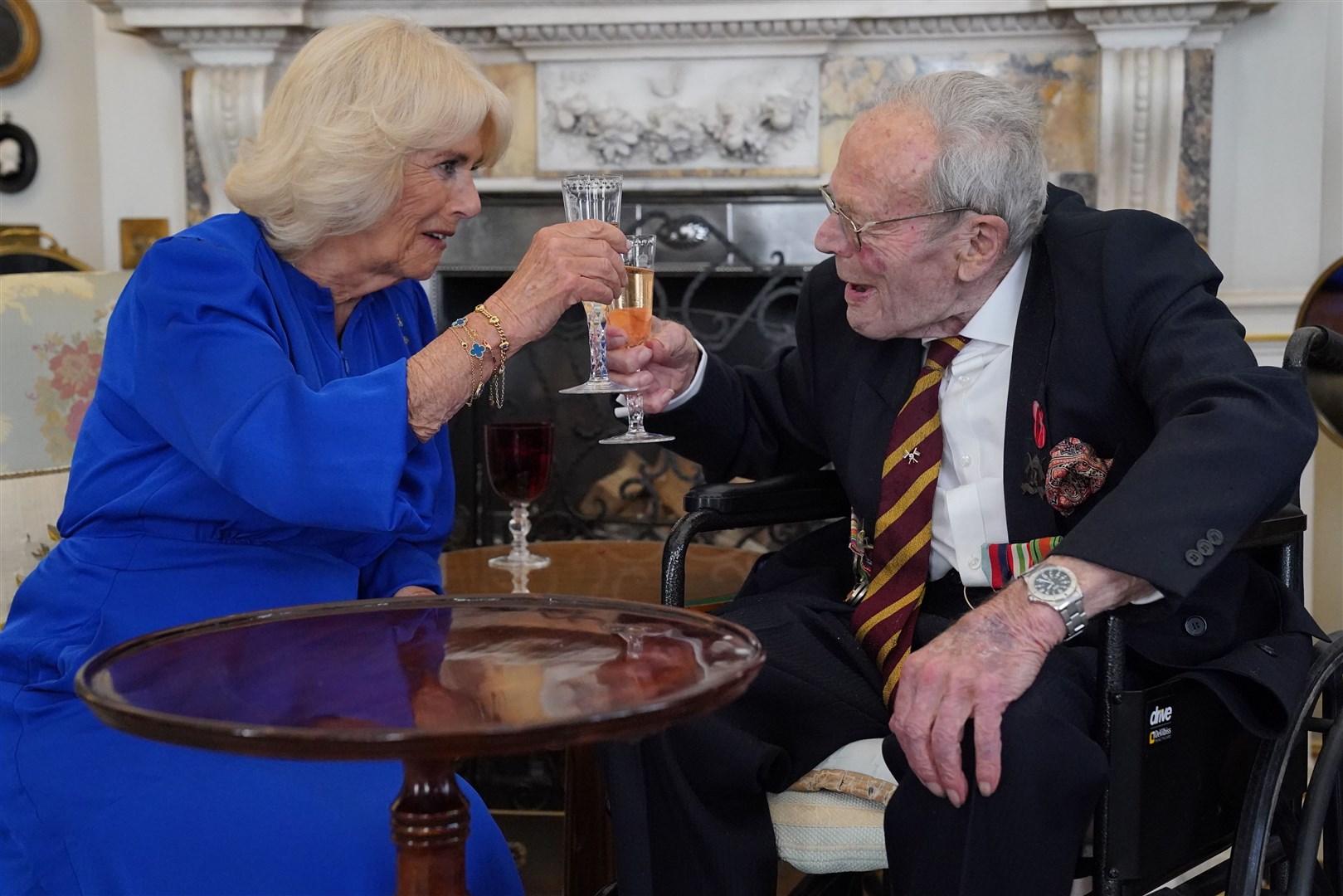 Queen Camilla toasts the health of Second World War veteran Michael de Burgh (Jonathan Brady/PA)