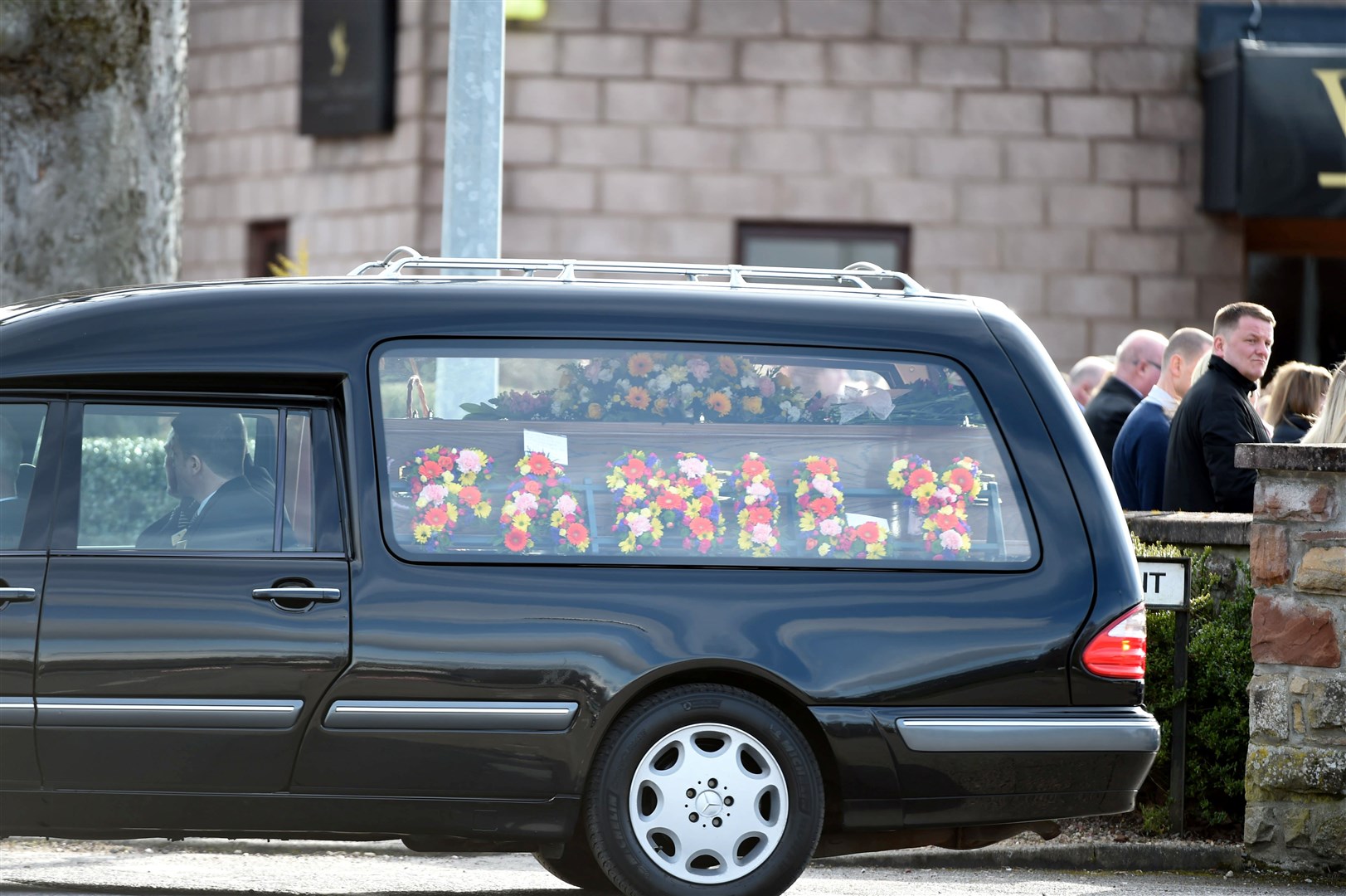 The cortège leaving William T Fraser and Son funeral home.