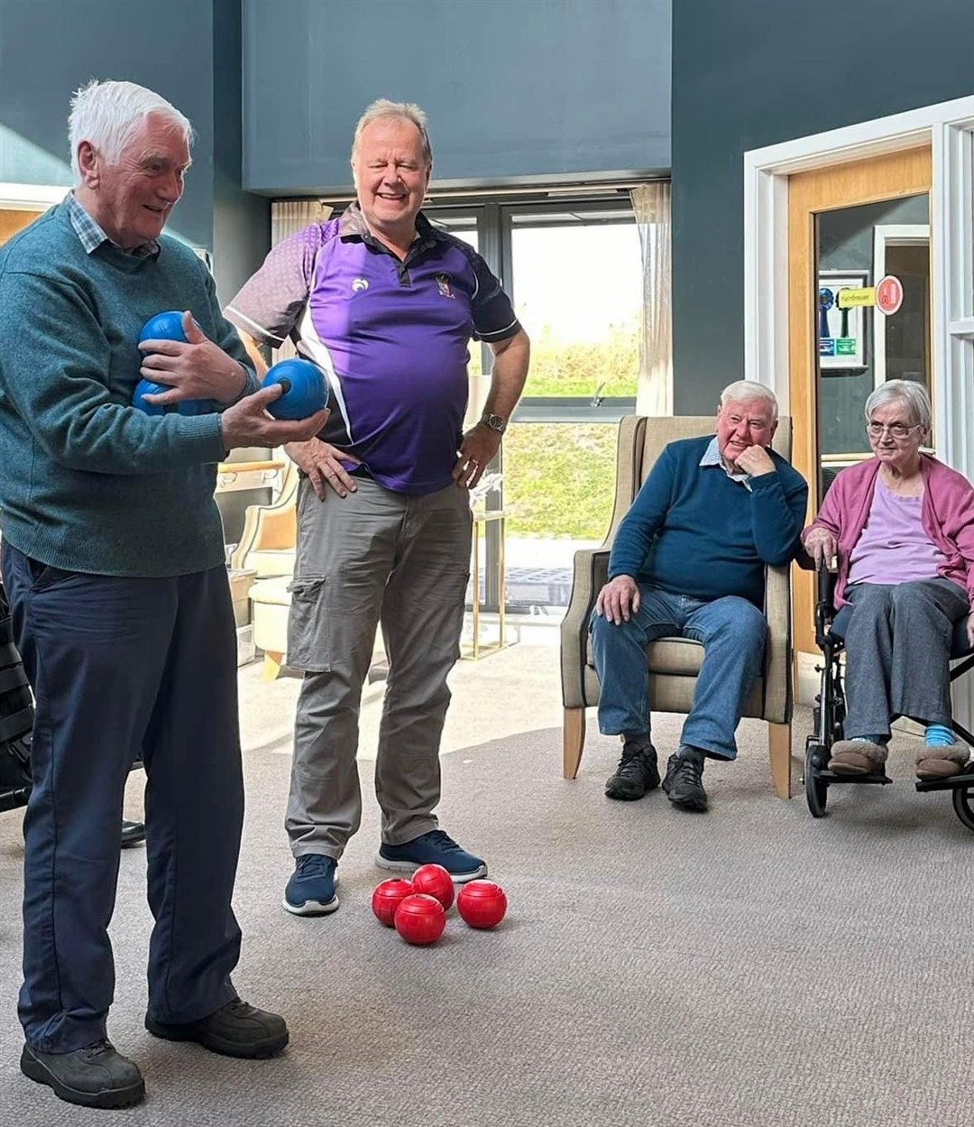 Fortrose & Rosemarkie Bowling Club president Alan Ogilvie with Cresswell Reed, a resident at Eilean Dubh Care Home in Fortrose. The club have provided indoor bowling sessions for residents. Picture: Parkland
