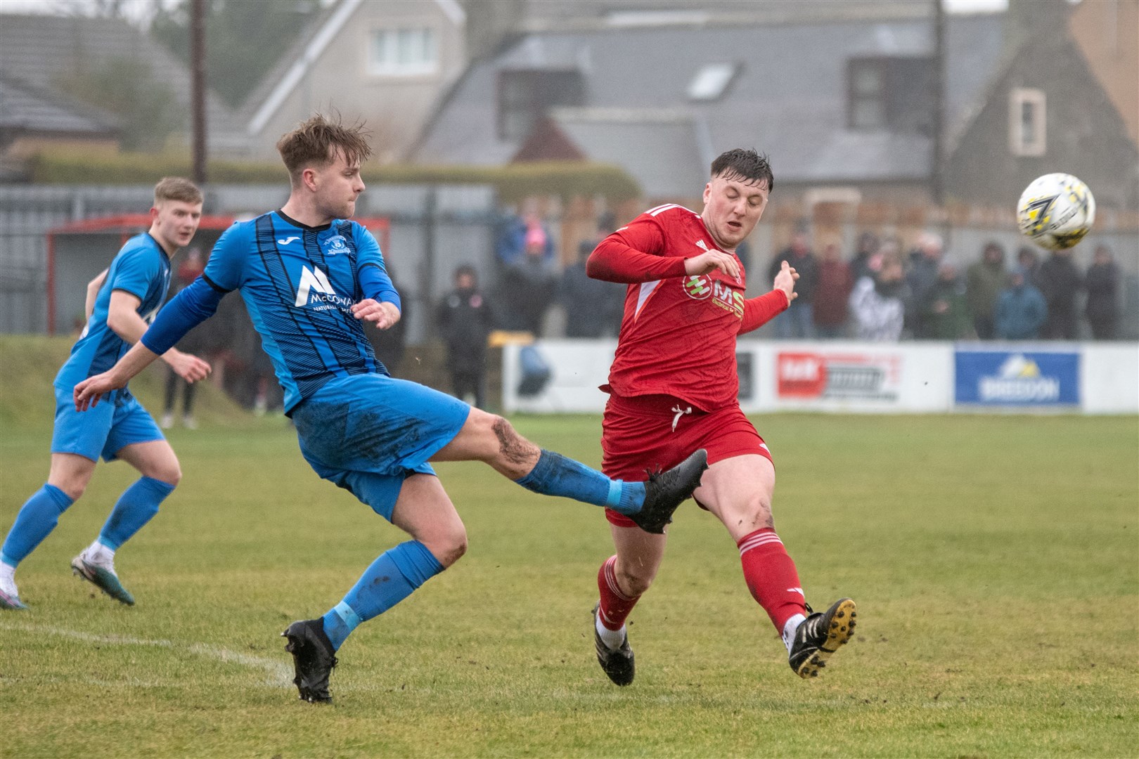 Strathspey's Michael McKenzie clears the ball away from Lossiemouth's Lewis McAndrew. ..Lossiemouth FC (2) vs Strathspey Thistle (1) - Highland Football League 23/24 - Grant Park, Lossie 10/02/2024...Picture: Daniel Forsyth..