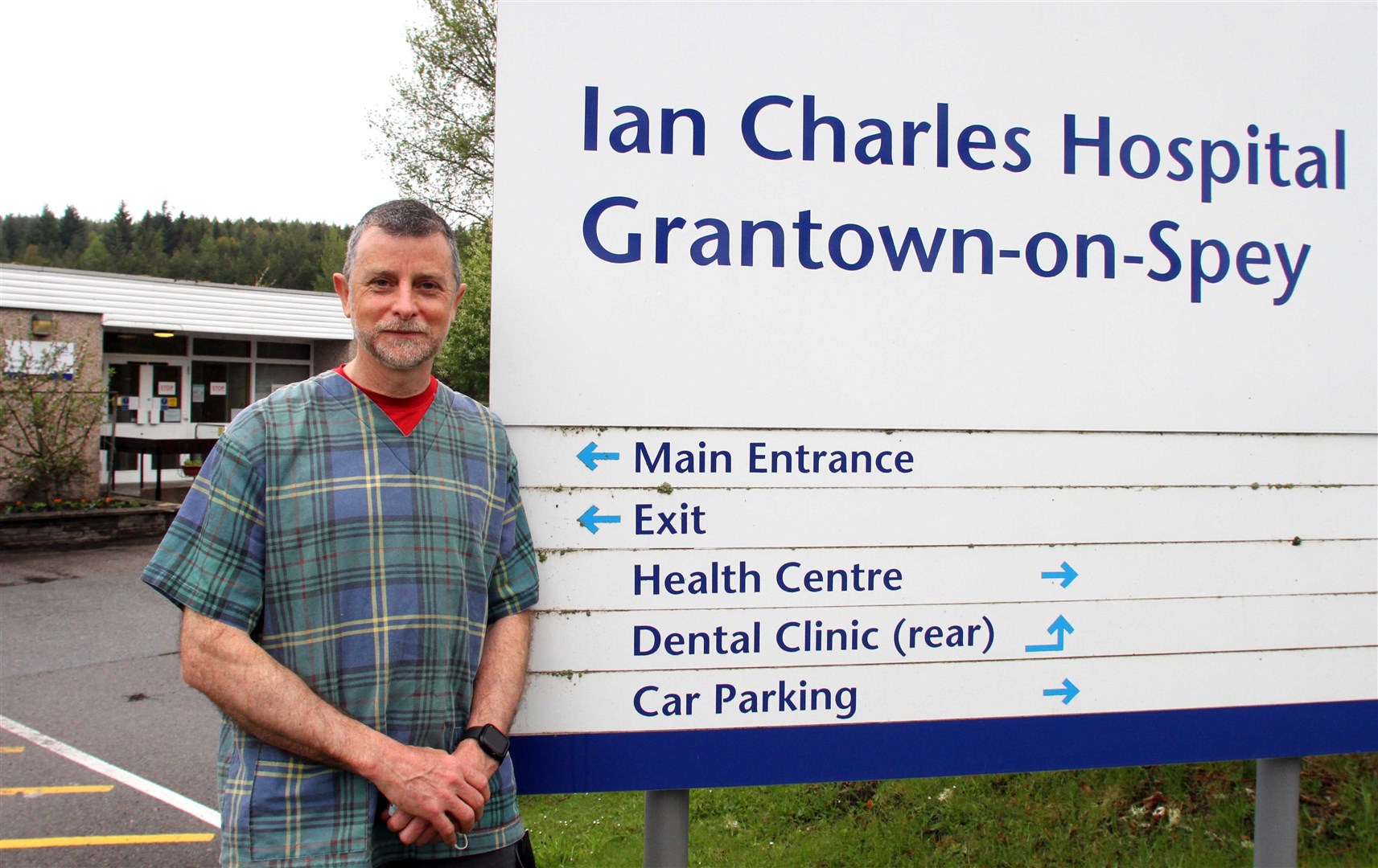 Dr Andrew Melton outside the entrance to the health centre and Ian Charles Hospital.