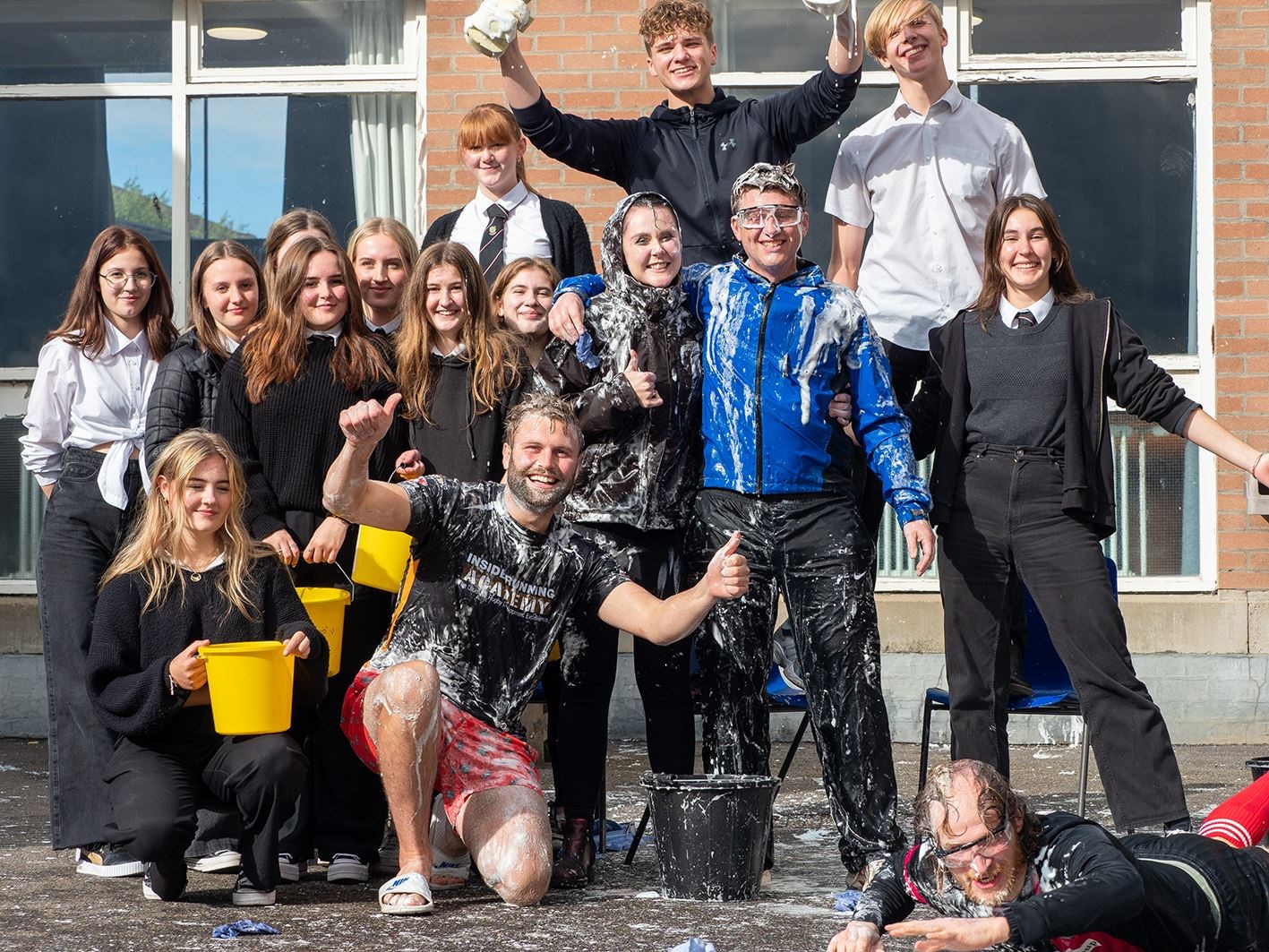 GOOD SPORTS: The teachers with some of the S6 pupils who did such a great job raising funds.
