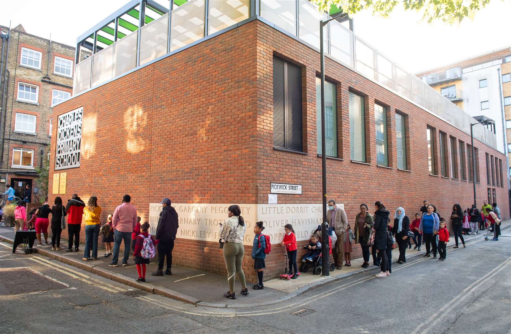 Pupils and parents were asked to queue up for drop-off on the first day back (Dominic Lipinski/PA)