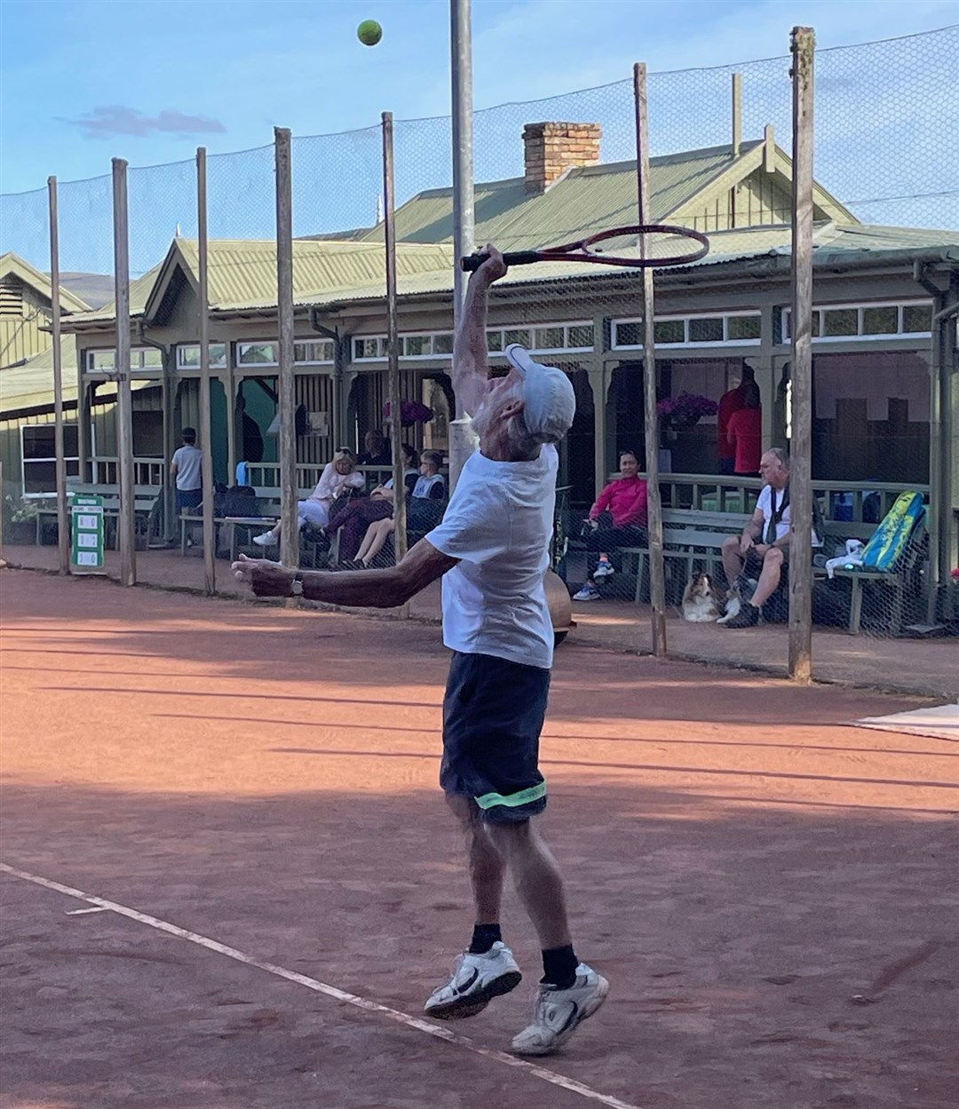 Grantown's Billy Mcleod serves in the handicap men's doubles contest. He was playing alongside his grandson Aaron and the pair won their tie.