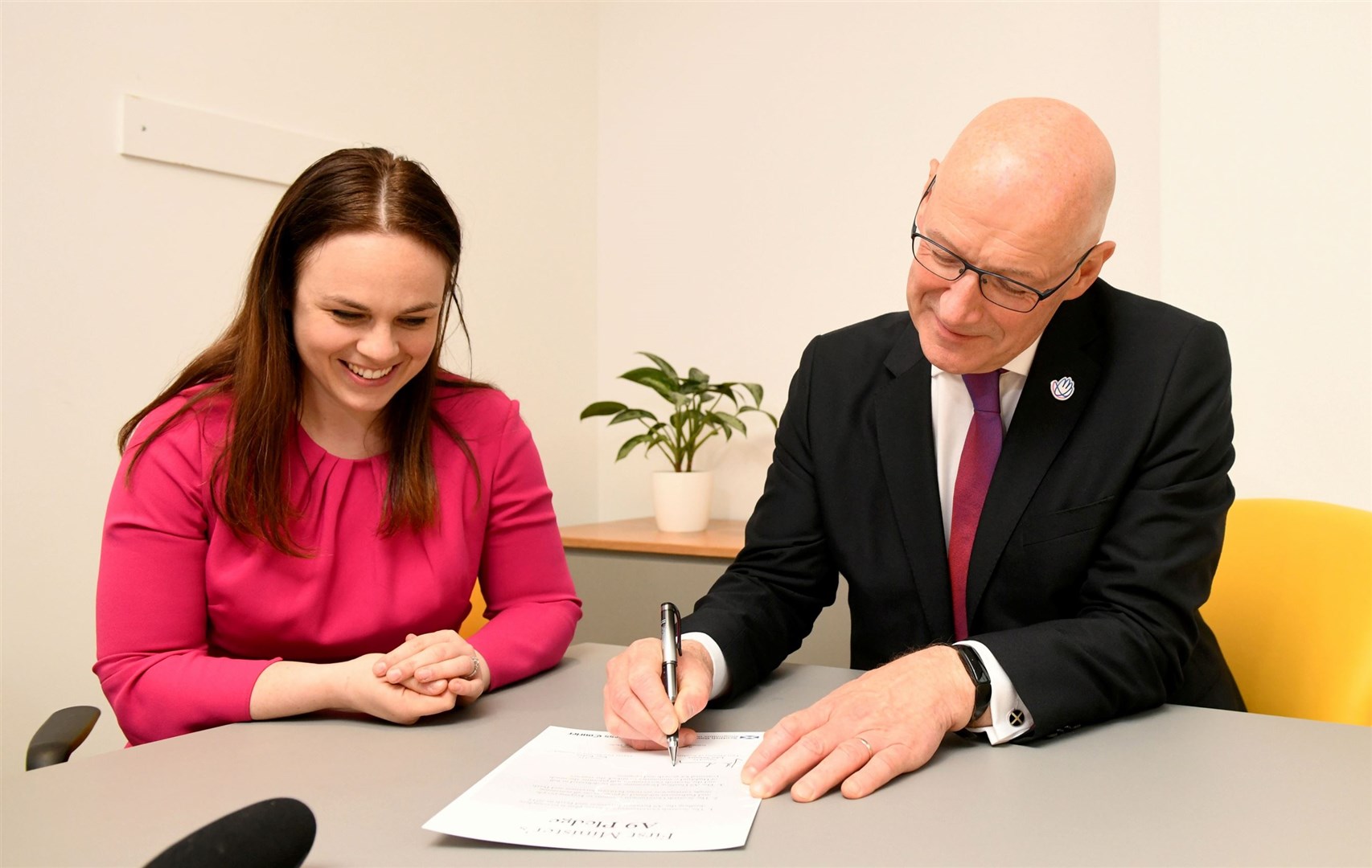 Kate Forbes watches as John Swinney puts pen to paper. Picture: James Mackenzie